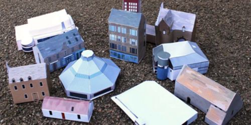 11 paper Scottish Buildings on the carpet being displayed