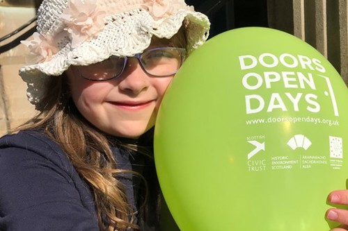 Visitor attending Doors Open Days holding a balloon